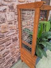 Load image into Gallery viewer, Side view image of the Mr Fox in a Box wicking planter box alongside a stylish arbour, showcasing its innovative self-watering system and modern garden design.