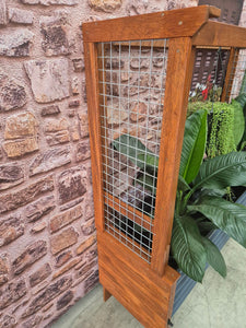 Side view image of the Mr Fox in a Box wicking planter box alongside a stylish arbour, showcasing its innovative self-watering system and modern garden design.